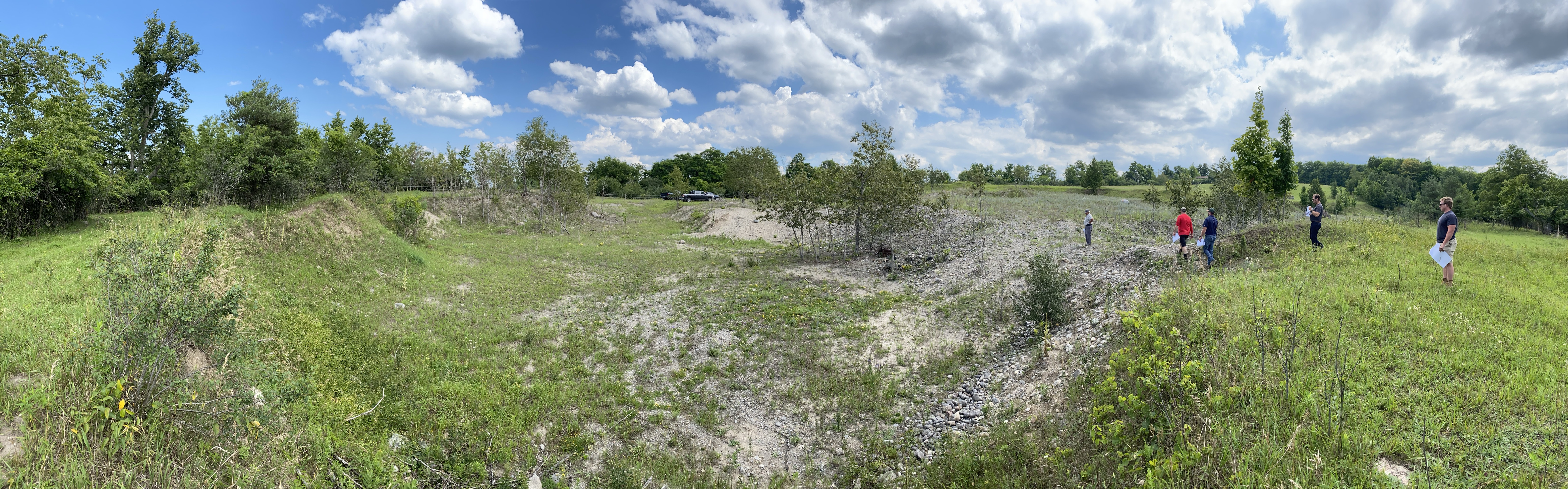 A photograph of the legacy site with slopes, barren areas and some safety concerns.